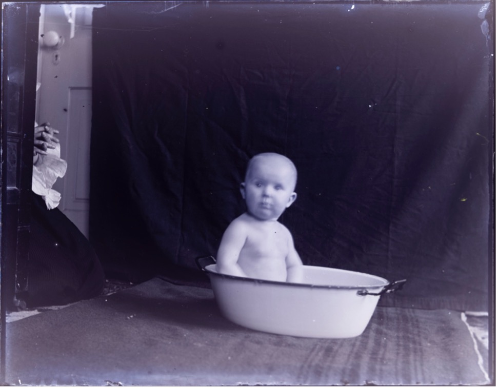 Baby sitting in a small tub