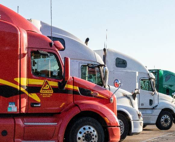 Row of semi trucks in a parking lot