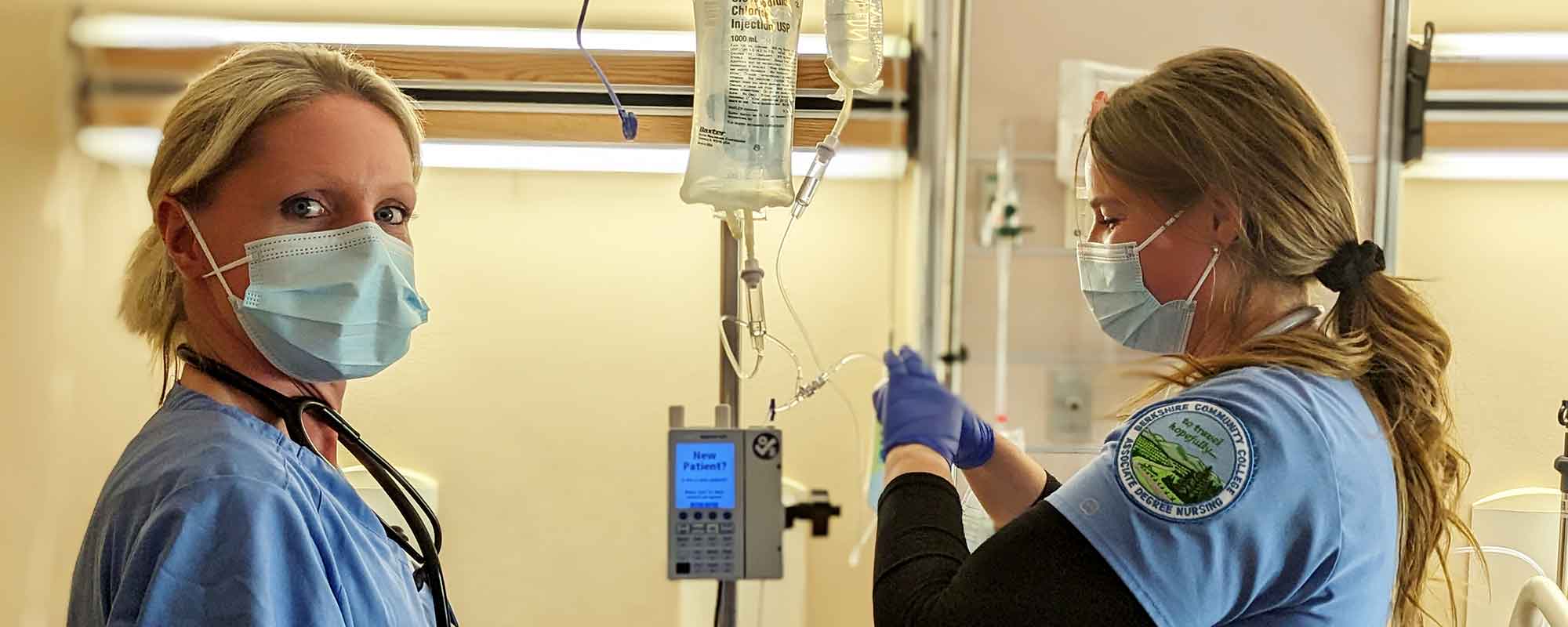 Students working in a simulated hospital room with a model patient