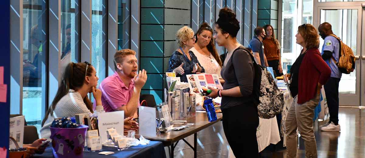 Students have a conversation while walking through the One Stop Center at BCC.